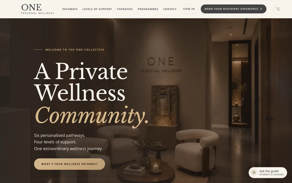 The ONE Personal Wellness homepage at desktop width: “A Private Wellness Community.” over a photograph of the studio lounge, with links to pathways, levels of support, therapies and programmes, and a button to book a Discovery Experience.
